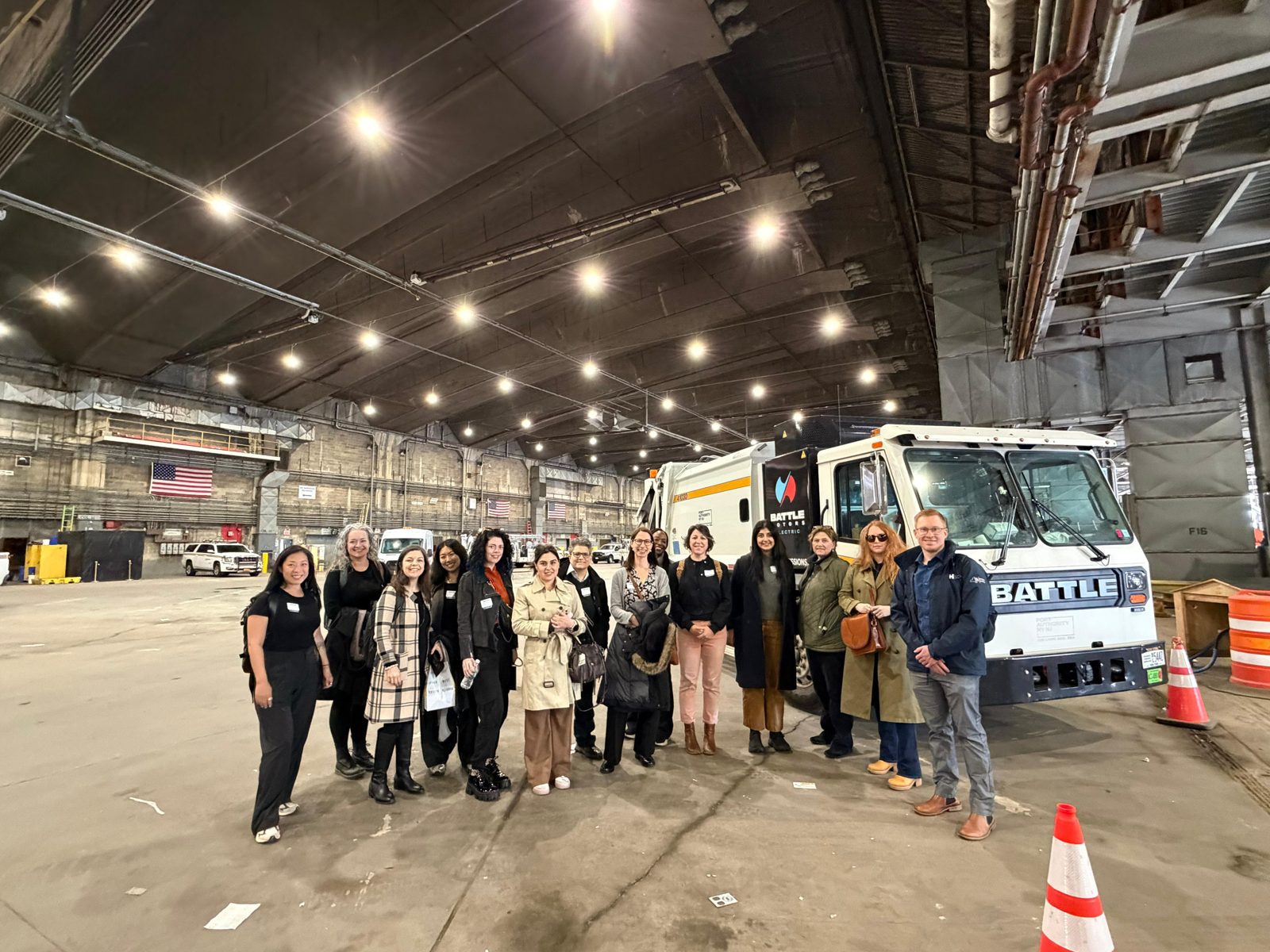 Women of EVs – NYC touring the JFK fleet maintenance garage with an electric refuse truck
